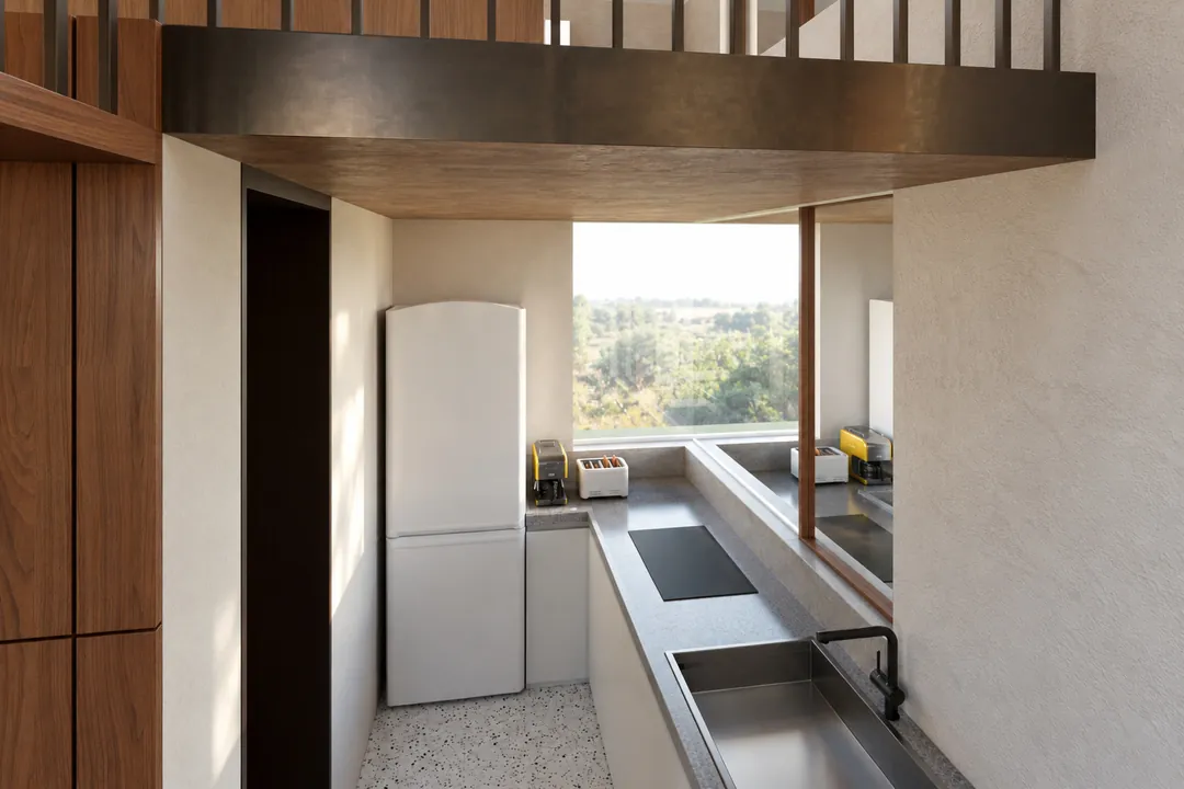 The compact kitchen under the loft, on a terrazzo floor