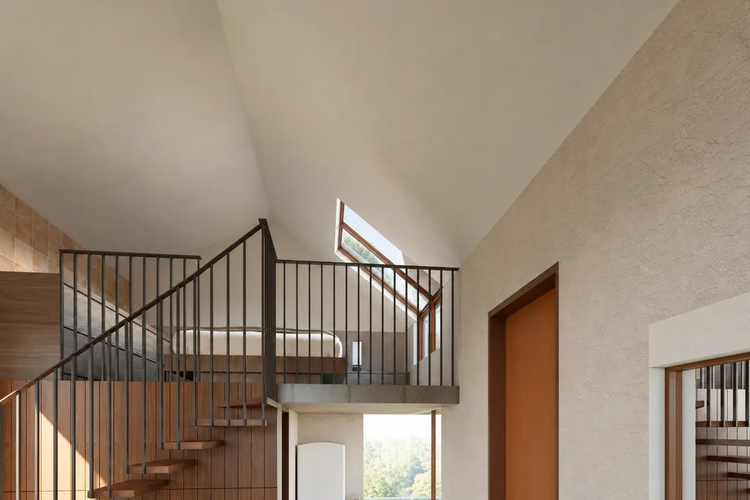 The loft bedroom behind a slender railing, under the gable