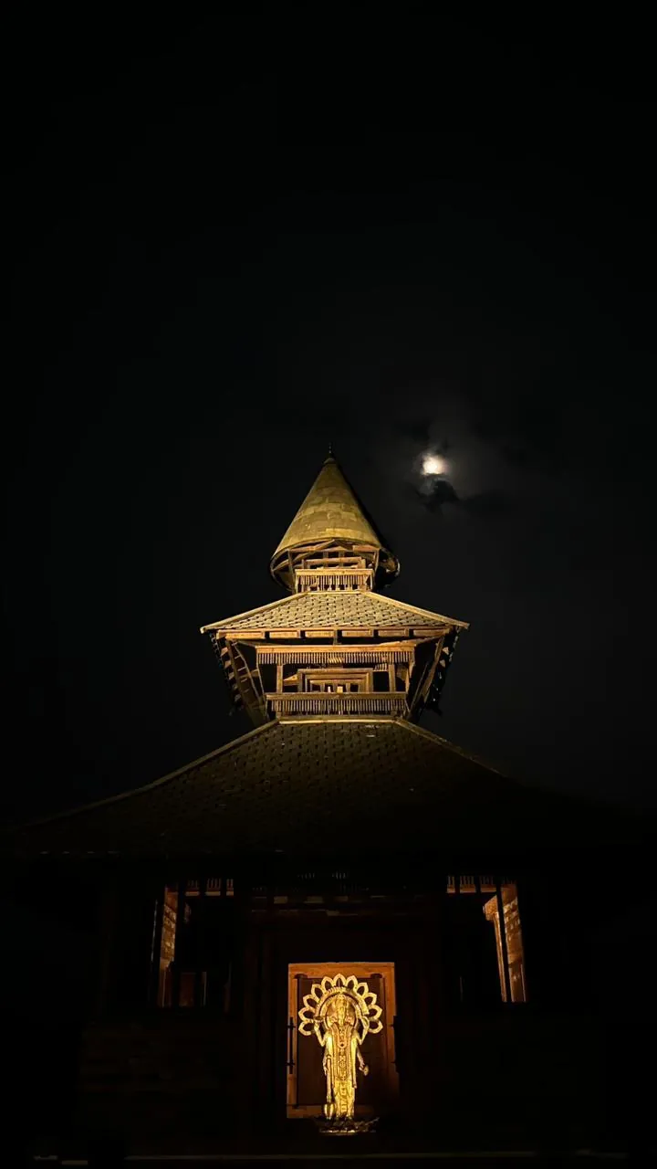 The temple lit from within at night