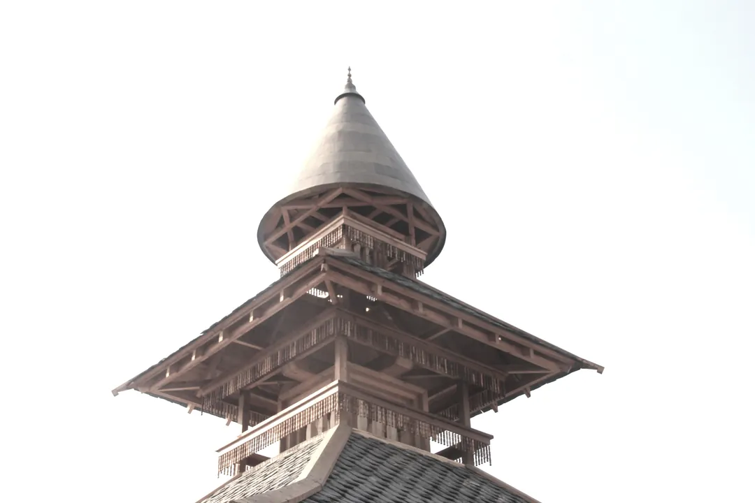 The temple's tiered timber roofs and spire against a pale sky